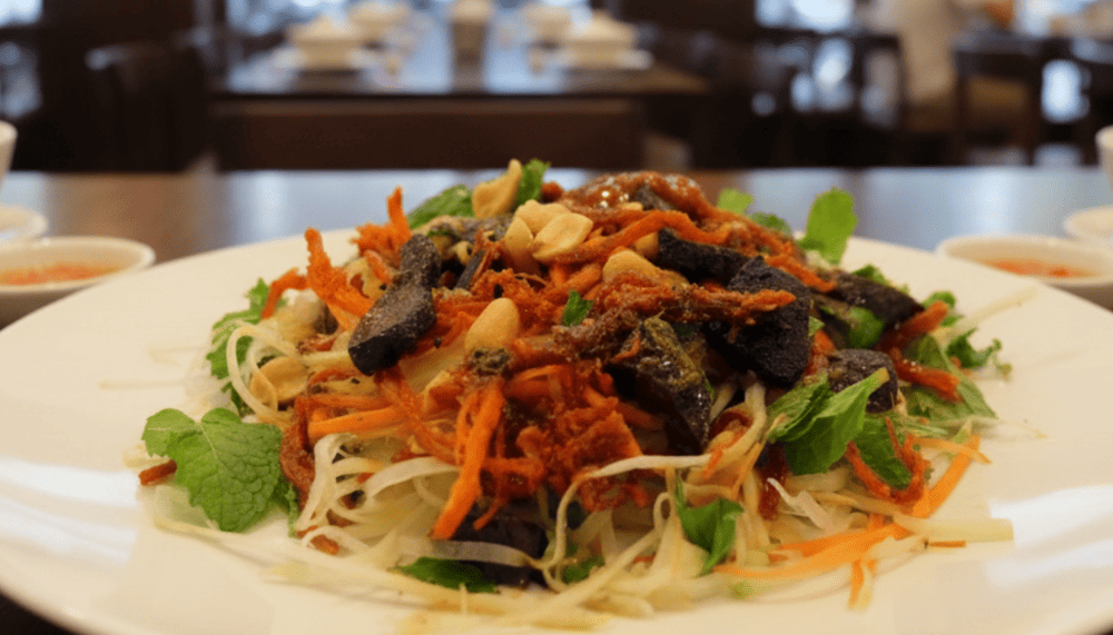 The dish features shredded green papaya, sweet-sour dressing, spicy chili, and chewy dried beef – a refreshing bite with a kick.